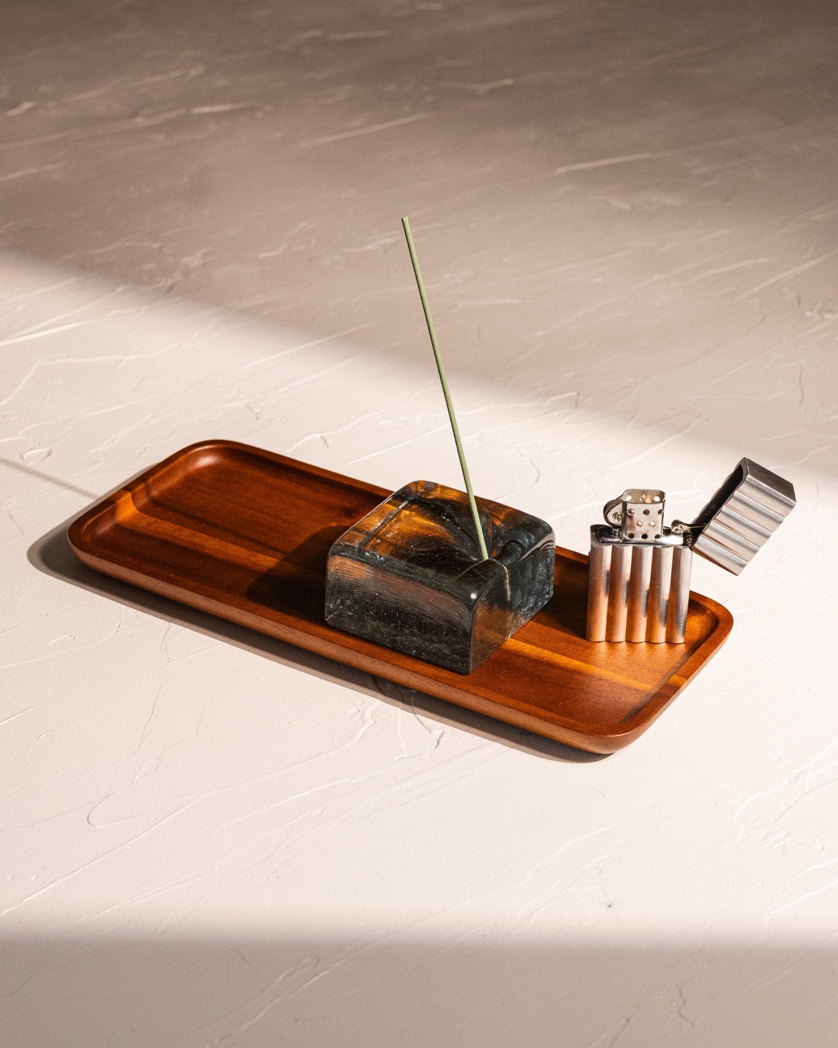 Acacia wood tray holding recycled glass incense holder and aluminum wave lighter
