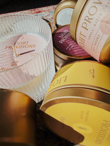 Collection of Light Provisions Blunder candles in many sizes and scents on vintage rug background - close up
