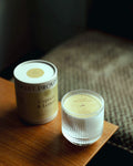 Cypress Lemon candle in glass tumbler alongside custom gift box and packaging
