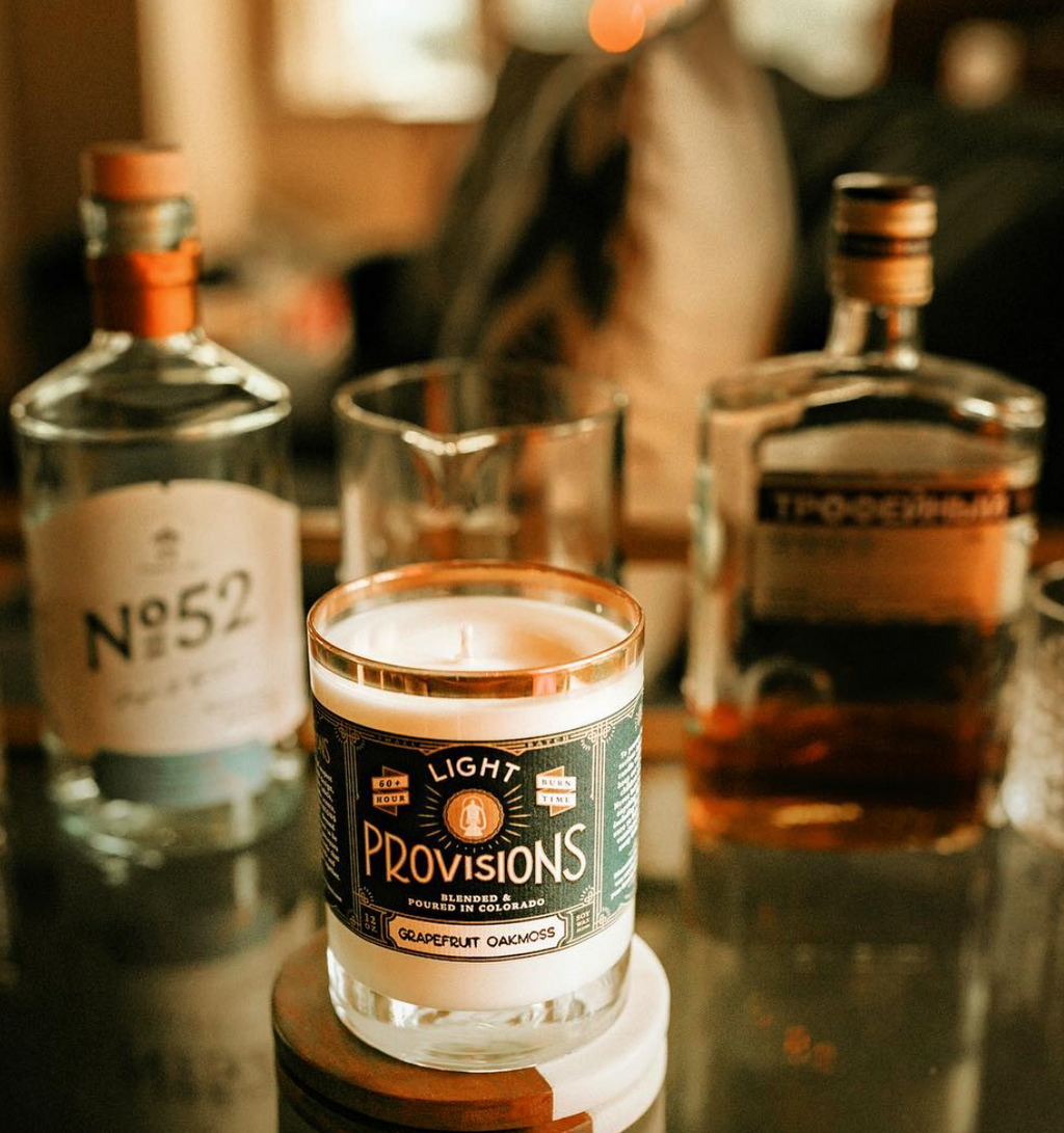 Light Provisions candle sitting on liquor shelf