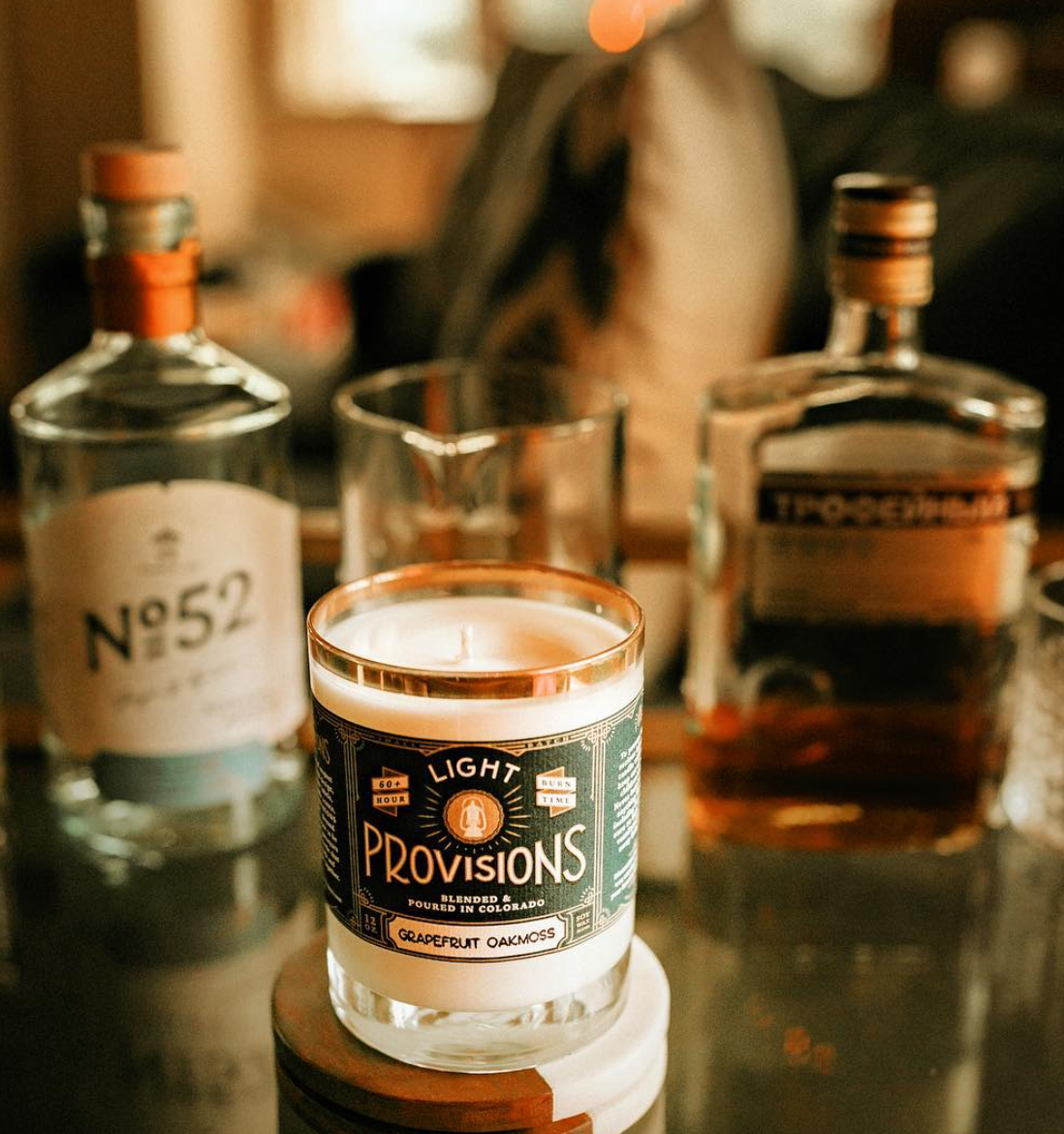 Light Provisions candle sitting on liquor shelf
