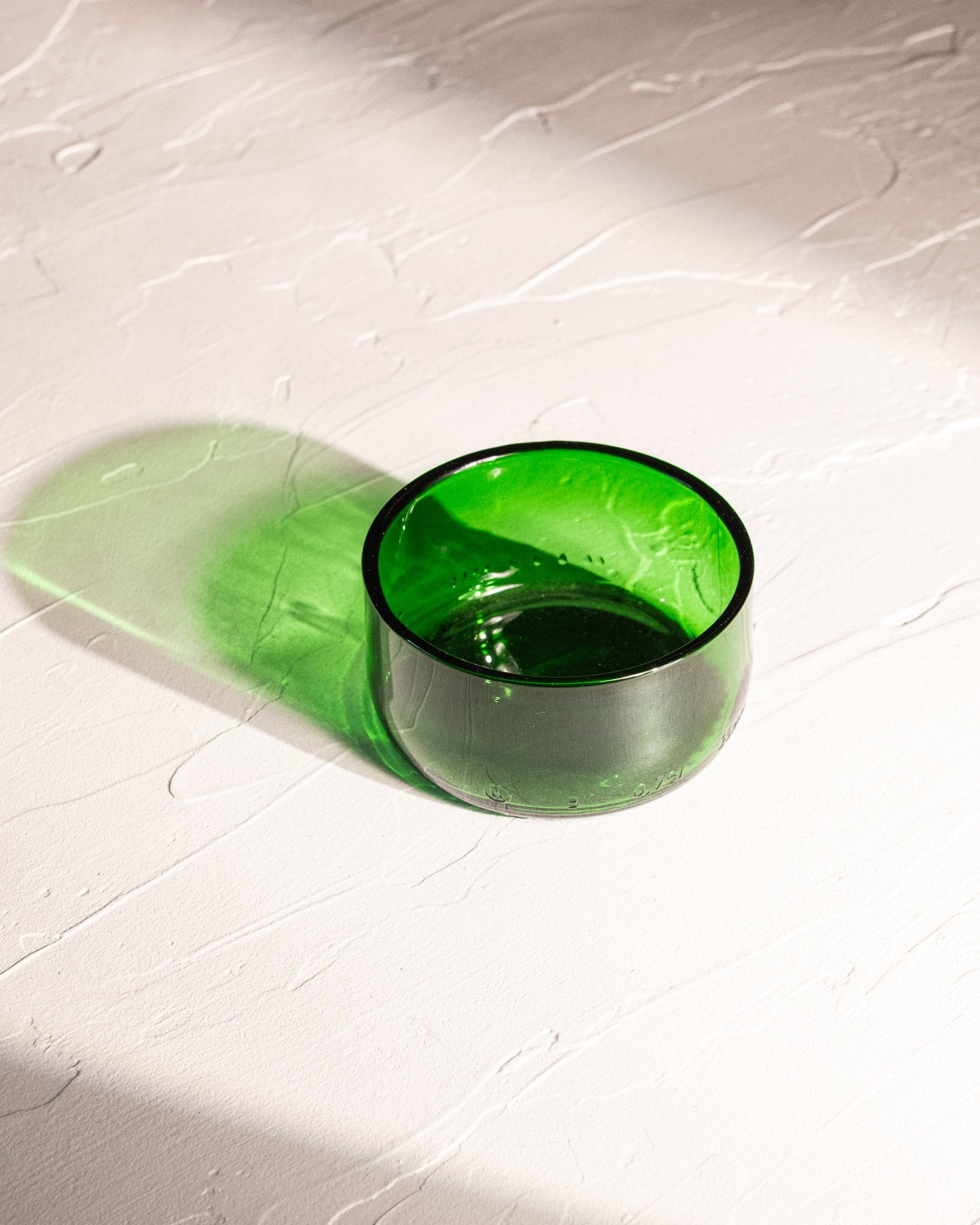 Green reclaimed bottle glass dish with rounded edge and translucent color
