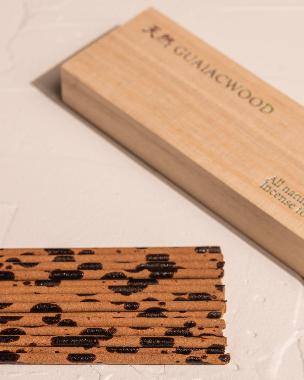 Close-up of Kousaido Guaiac Wood incense sticks showing natural resin markings
