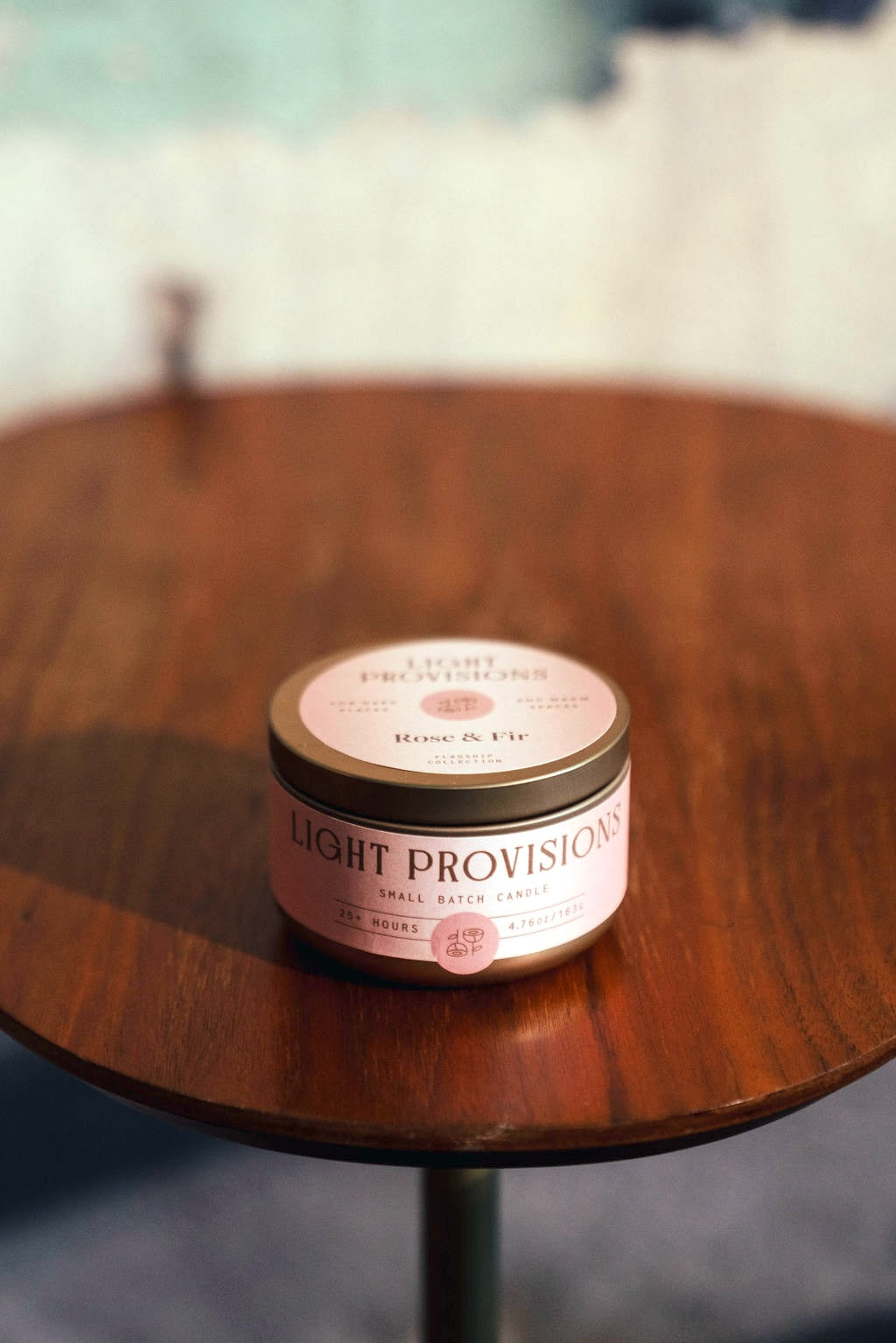 Rose & Fir candle tin with lid closed on wooden table