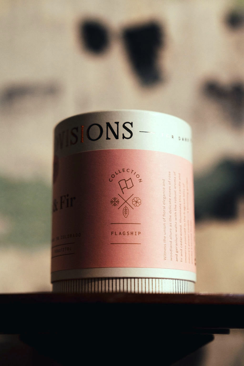 Close-up of Rose & Fir tube packaging on wooden table