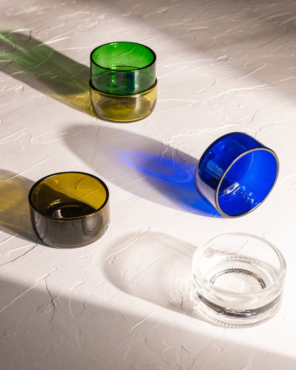 Reclaimed bottle glass dishes in amber, olive, blue, green, and clear colors