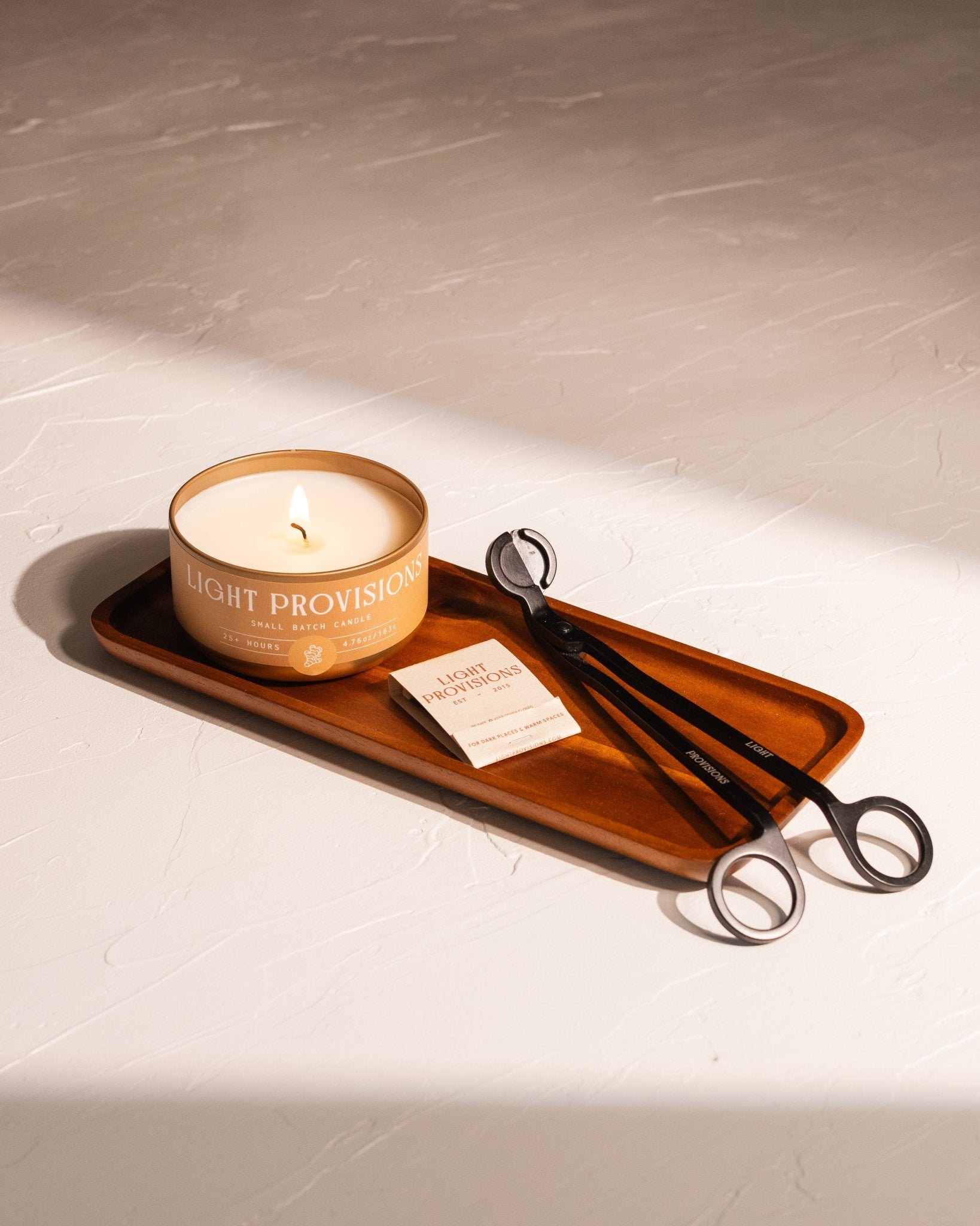 Acacia wood tray styled with Light Provisions candle, matches, and wick trimmers