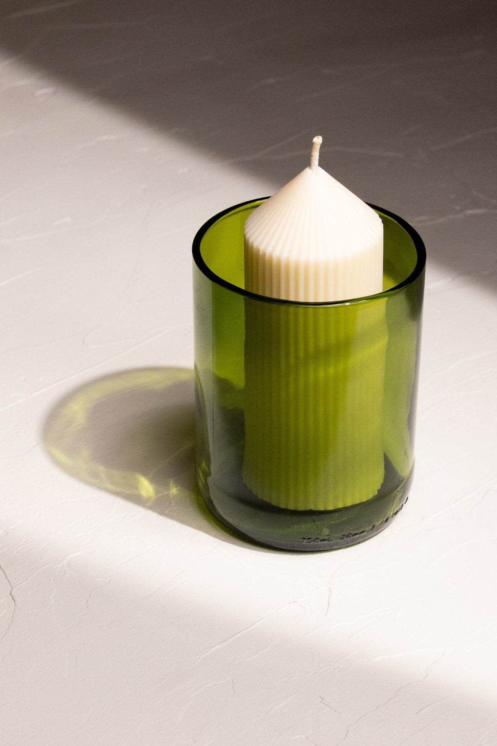 LP refill candle shown in a recycled glass kelly green glass made from discarded wine bottles