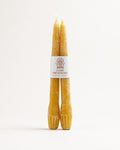 Pair of hand-dipped beeswax taper candles with Light Provisions label, natural golden color
