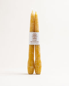 Pair of hand-dipped beeswax taper candles with Light Provisions label, natural golden color