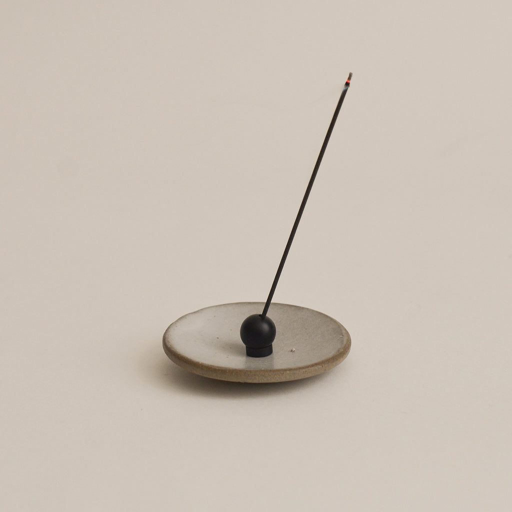 Black sphere adjustable incense holder with incense stick