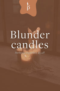 Candle with text 'Blunder candles Perfectly imperfect, $5 off' on a brown background