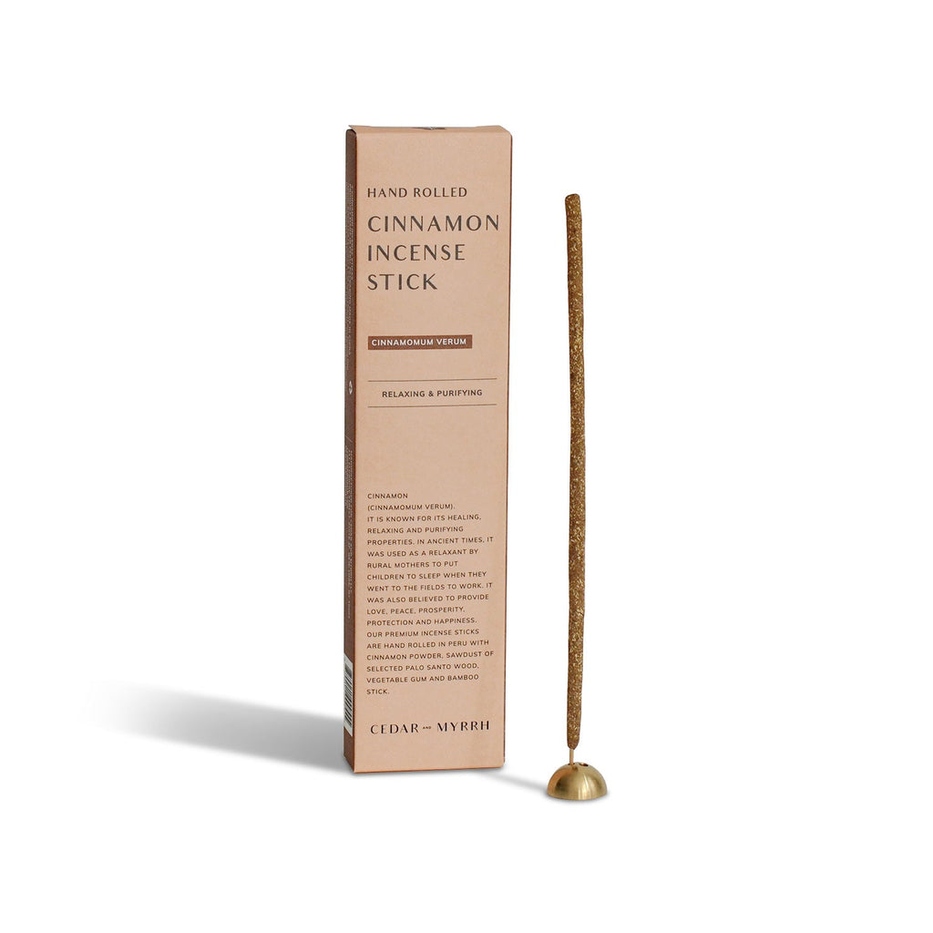 Cinnamon hand-rolled incense sticks with packaging on a white background