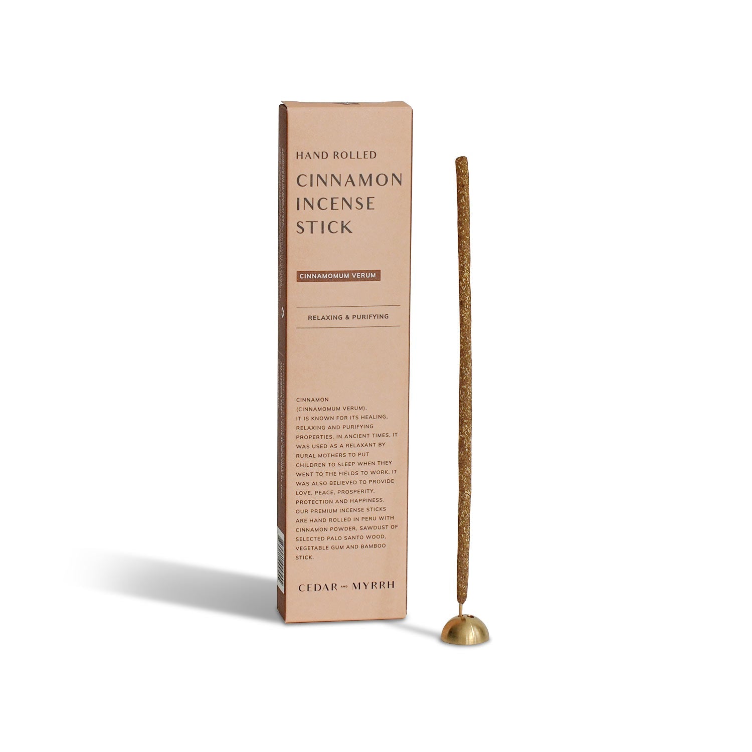 Cinnamon hand-rolled incense sticks with packaging on a white background