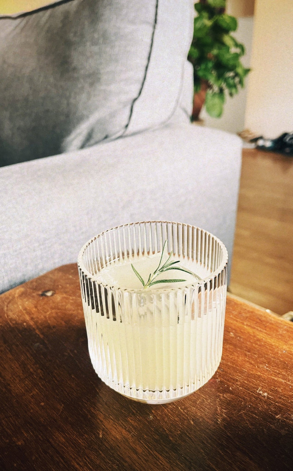 Ribbed Light Provisions glassware containing a citrus cocktail on a vintage nightstand