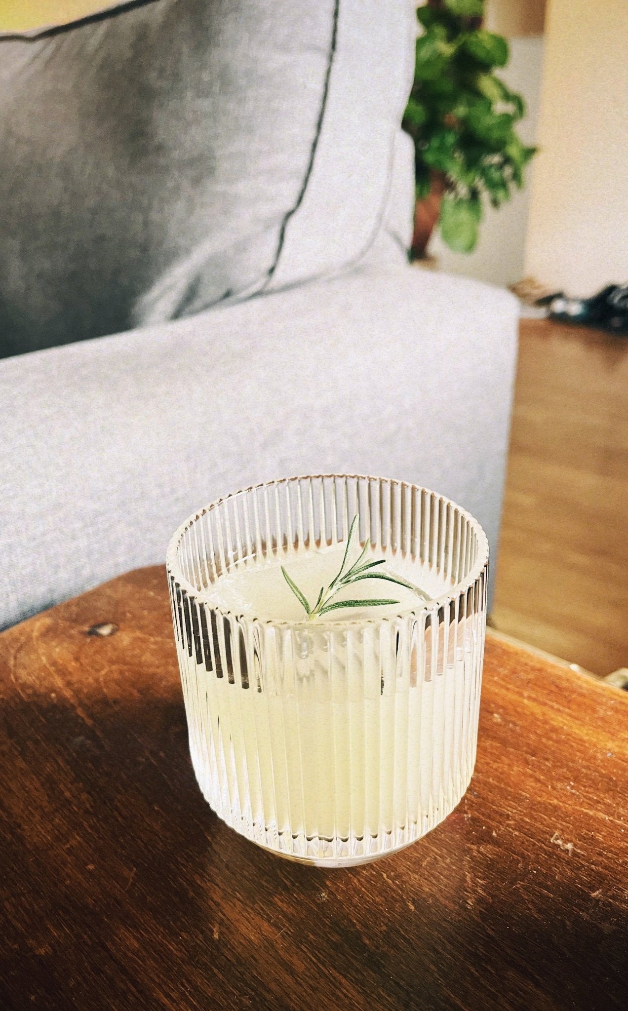Ribbed Light Provisions glassware containing a citrus cocktail on a vintage nightstand