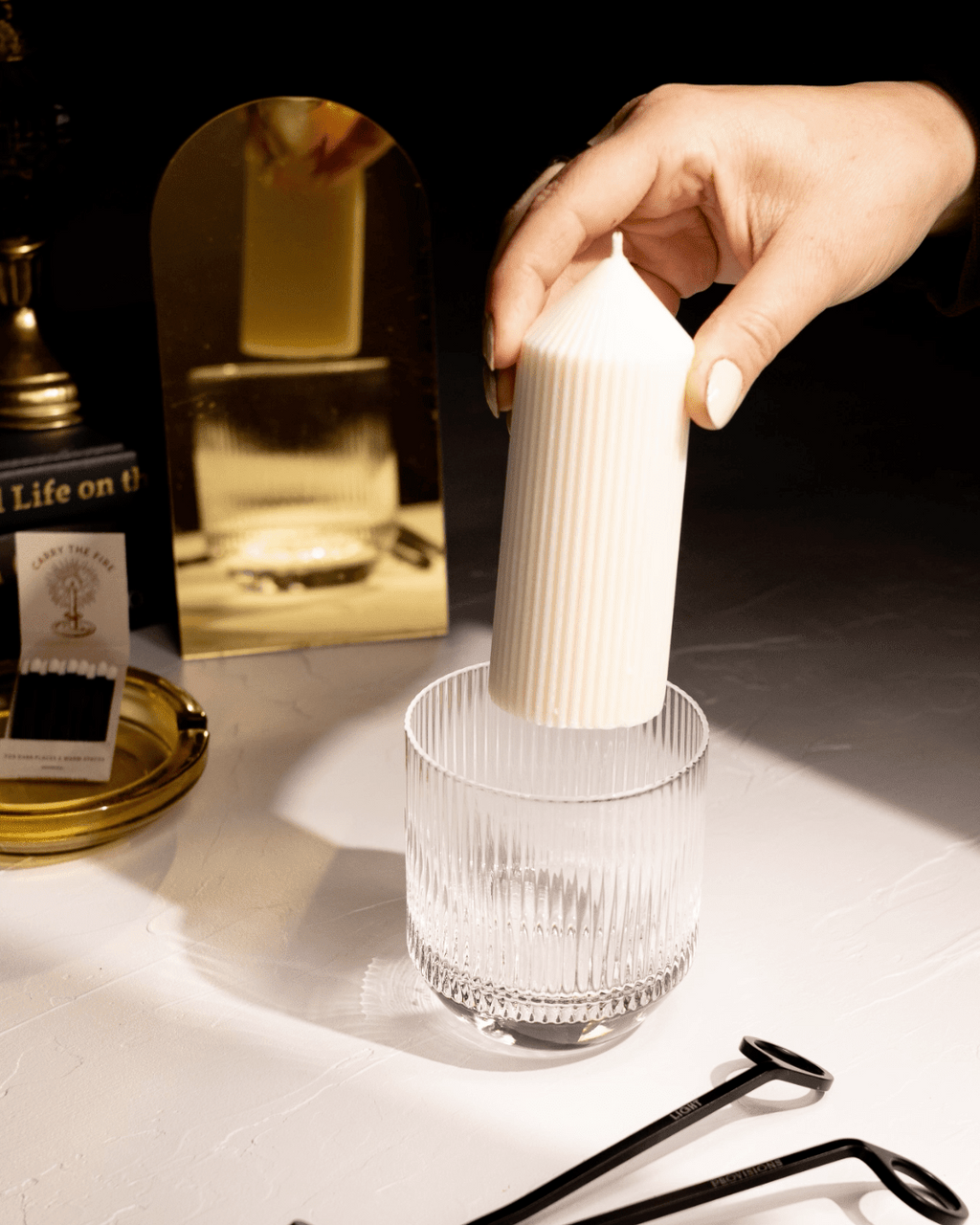 Cypress & Lemon travel tin candle styled with its packaging on a tabletop