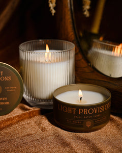 Light Provisions Dry Leaves & Cardamom candle in glass tumbler and travel tin with warm autumn styling