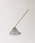 Incense holder with a single incense stick on a white background