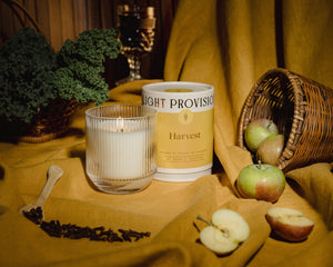 Light Provisions Harvest candle signature glass tumbler displayed with apples and wicker basket for autumn décor inspiration