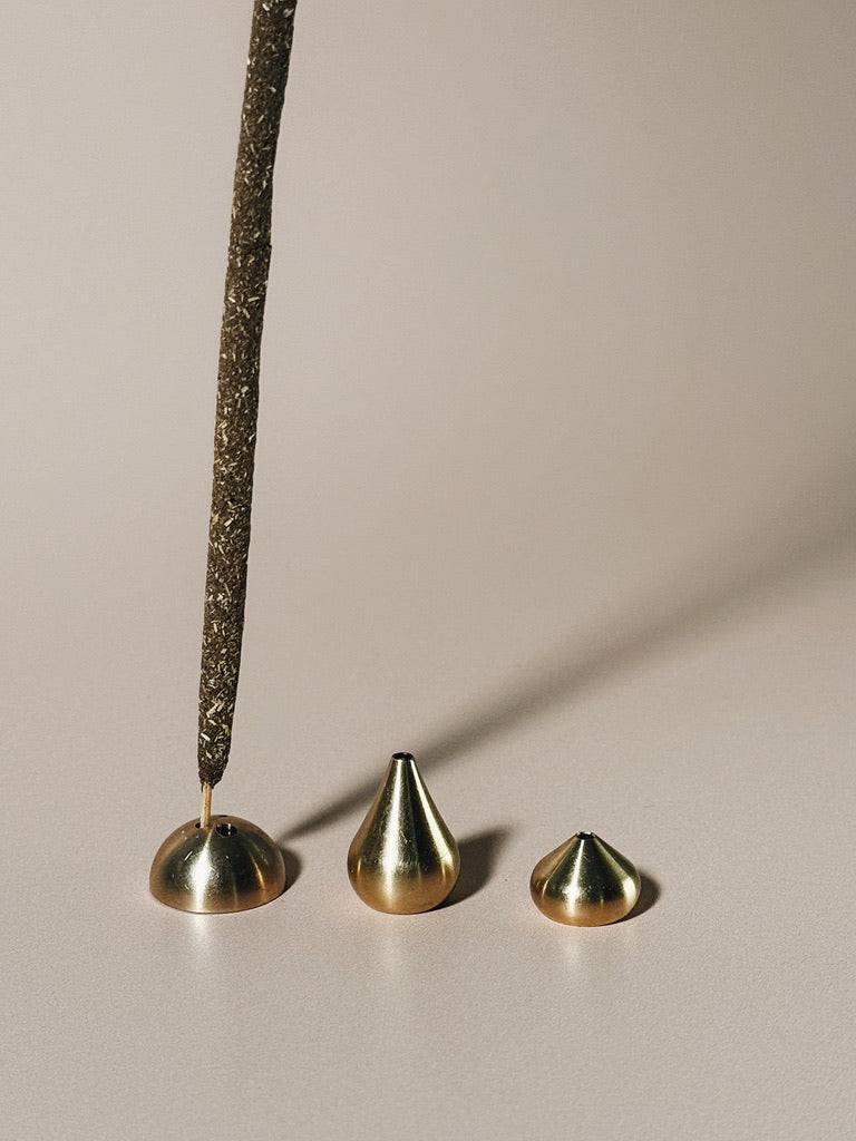 Brass incense holders grouped together, showing compatibility with incense stick sizes.