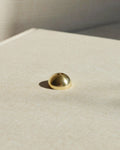 Brass hemisphere incense holder shown alone on a light surface, designed to hold multiple incense sizes.