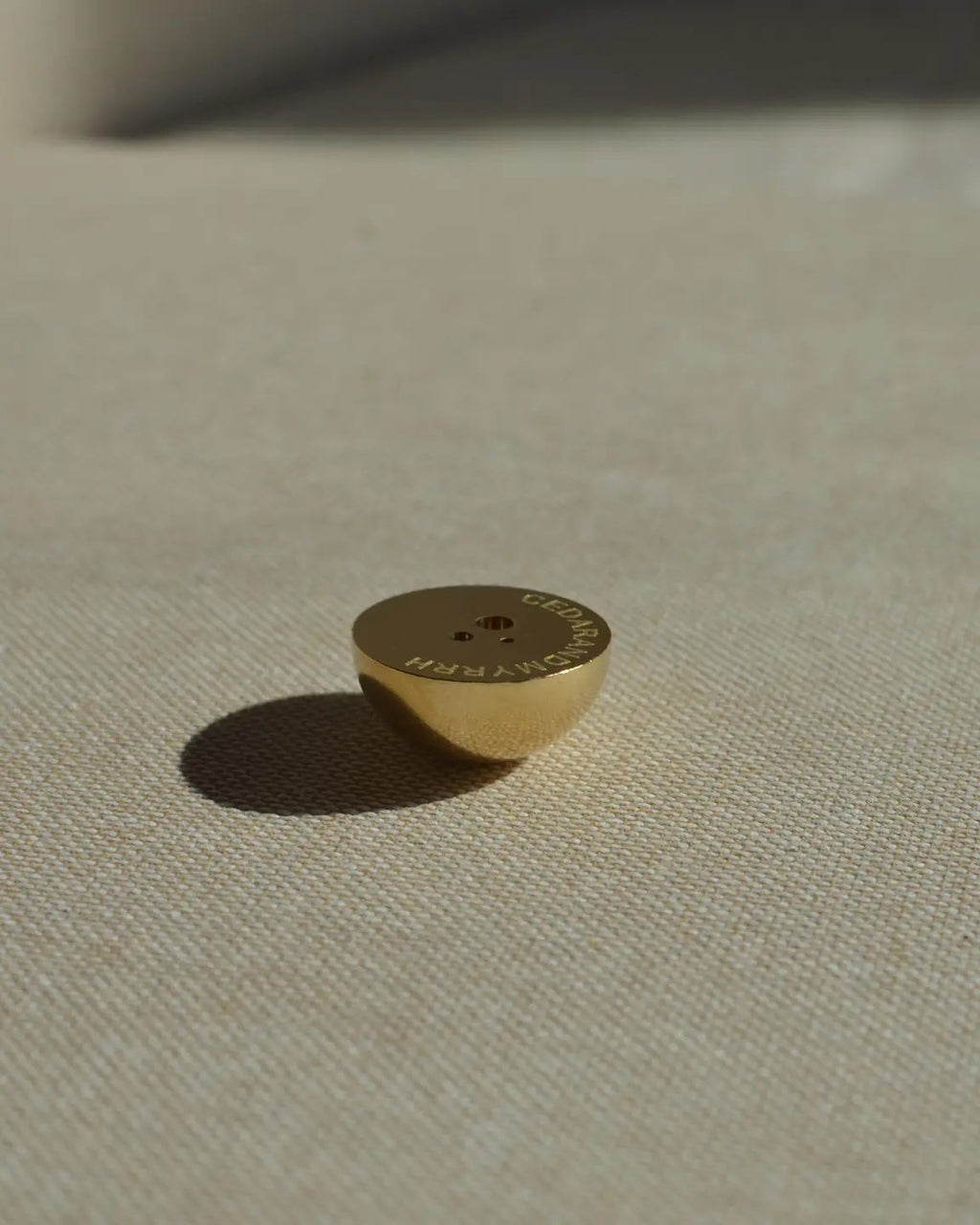 Hemisphere Brass Incense Holder small solid brass dome showing three hole sizes for incense sticks, with Cedar and Myrrh printed underneath