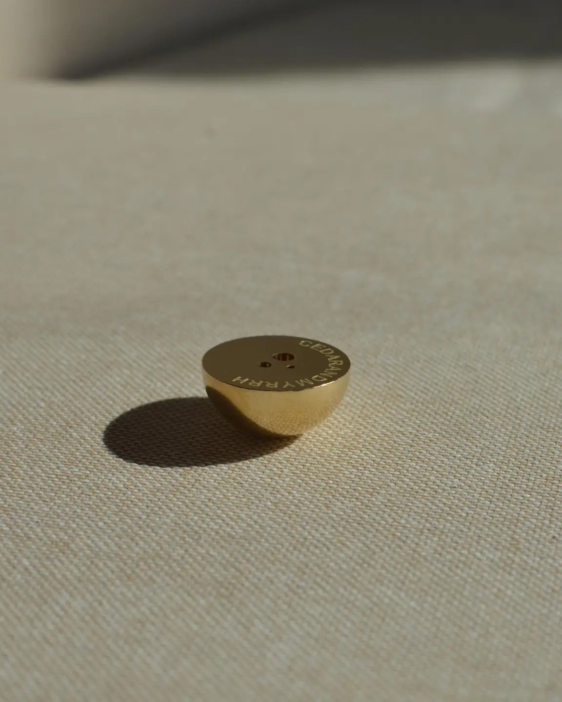 Hemisphere Brass Incense Holder small solid brass dome showing three hole sizes for incense sticks, with Cedar and Myrrh printed underneath
