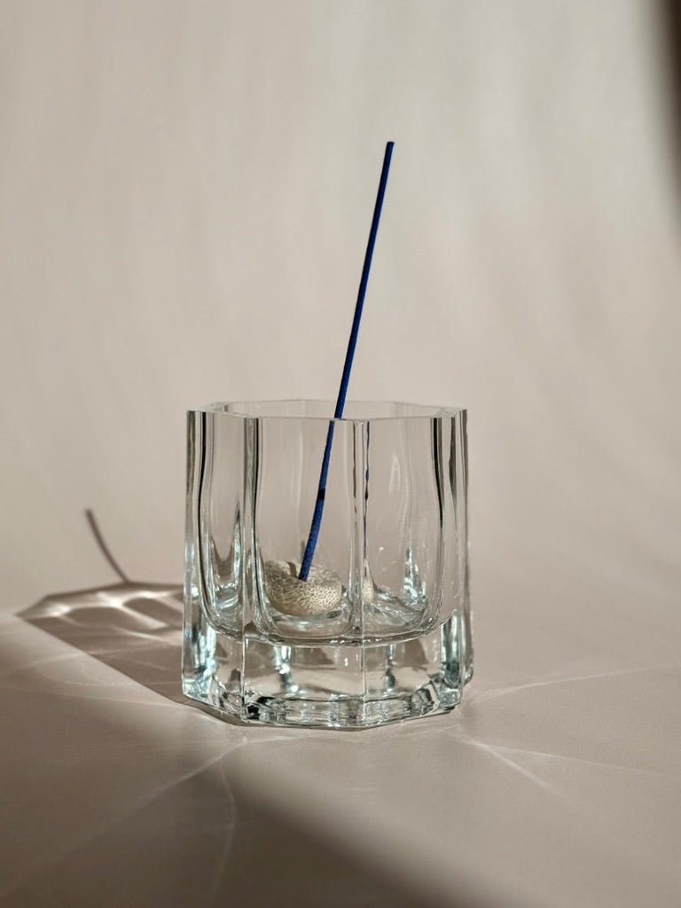 navy blue agarwood incense stick in pebble holder in recycled St. Germaine glass dish