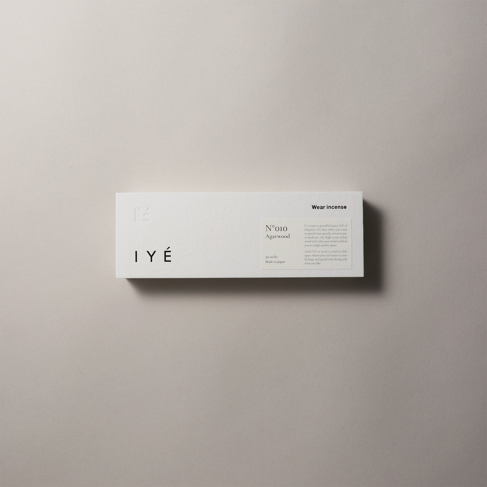IYé agarwood incense packaging on a beige background