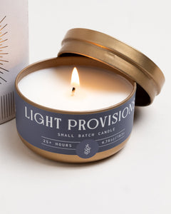 Elderflower + Driftwood travel candle in gold tin with airy floral and cool coastal scent.