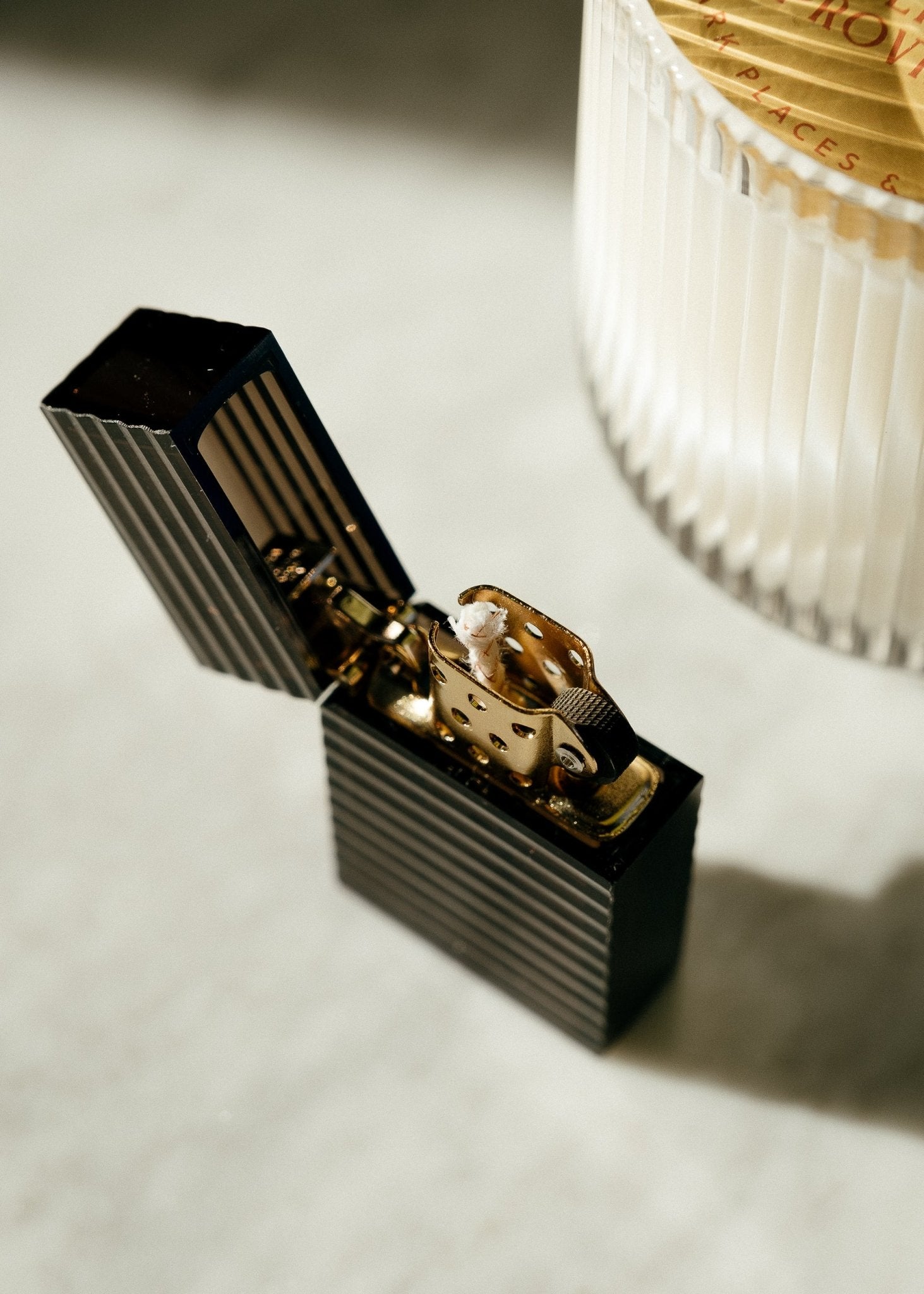 Latitude Hard-edge Lighter by Tsubota Pearl in ridged pattern styled next to candle, made in Japan