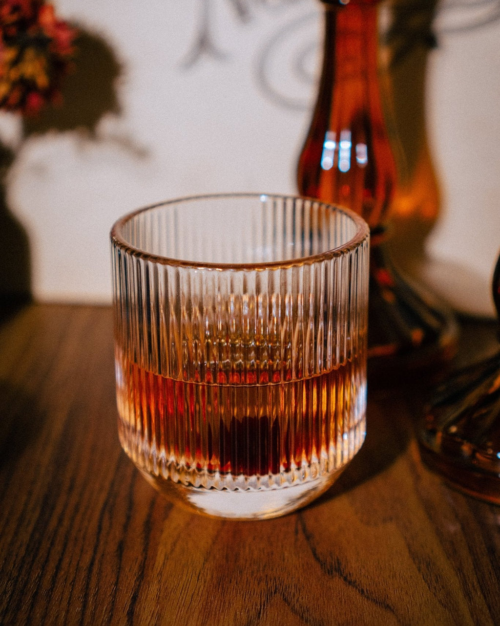 Bespoke handcrafted glassware shown with whiskey on vintage wooden surface with harvest neil young album in background