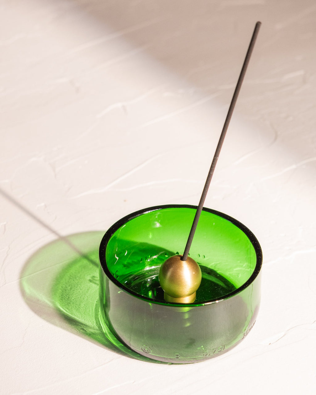 Sphere brass incense holder in green glass recycled wine bottle vessel