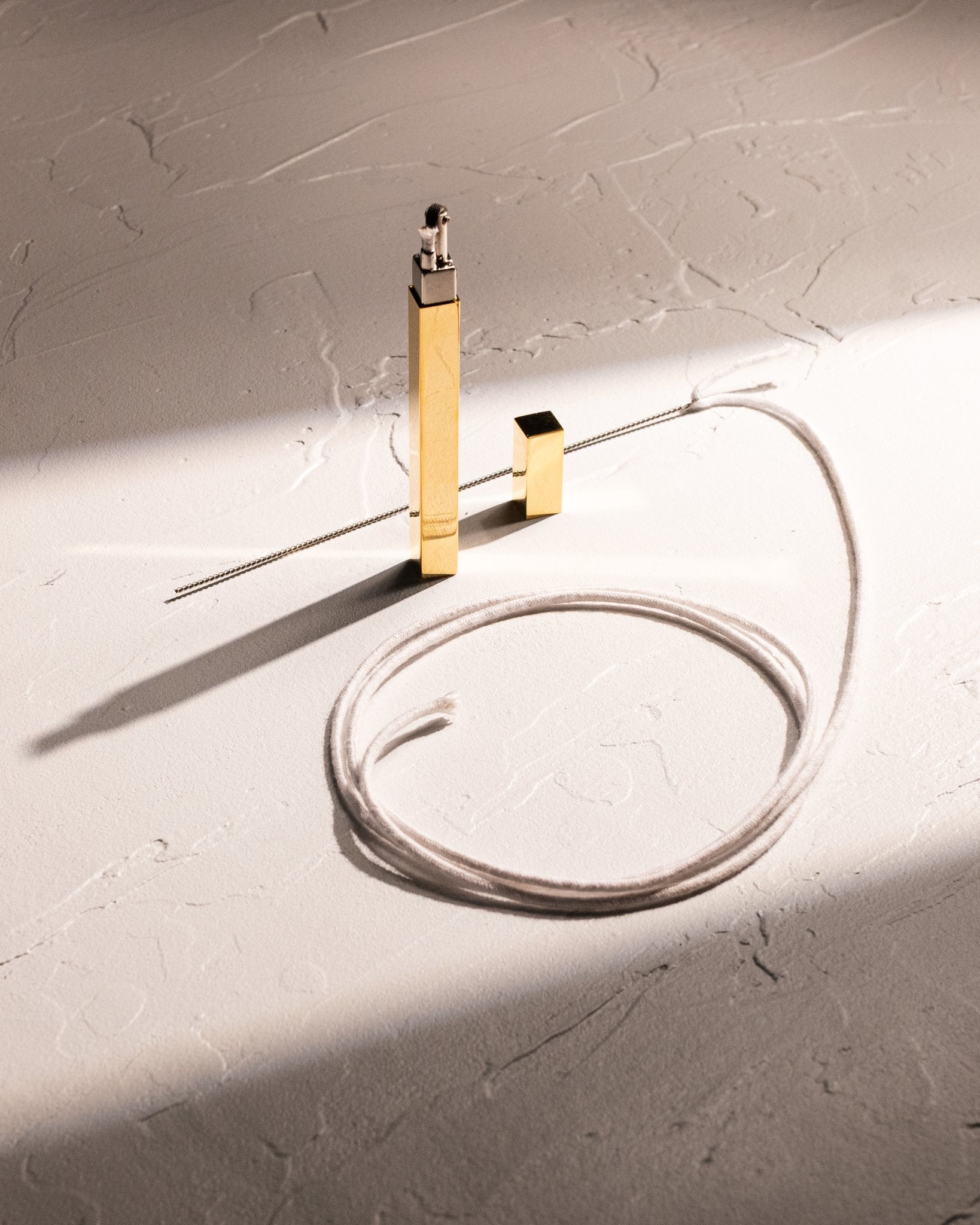Replacement cotton wick pictured with gold Queue stick lighter by Tsubota Pearl