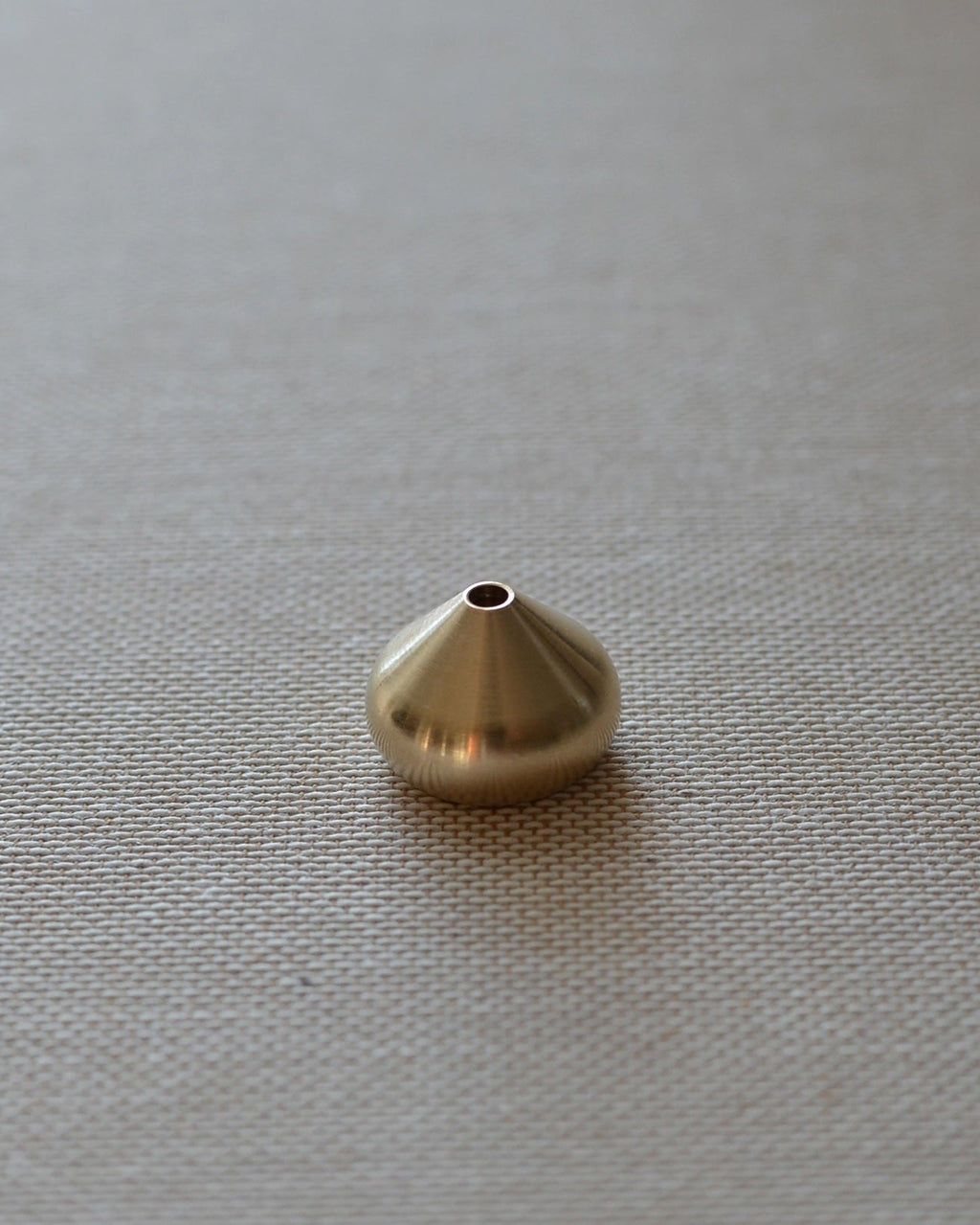 Medium brass waterdrop incense holder shown alone on a neutral surface, suitable for core and coreless incense.
