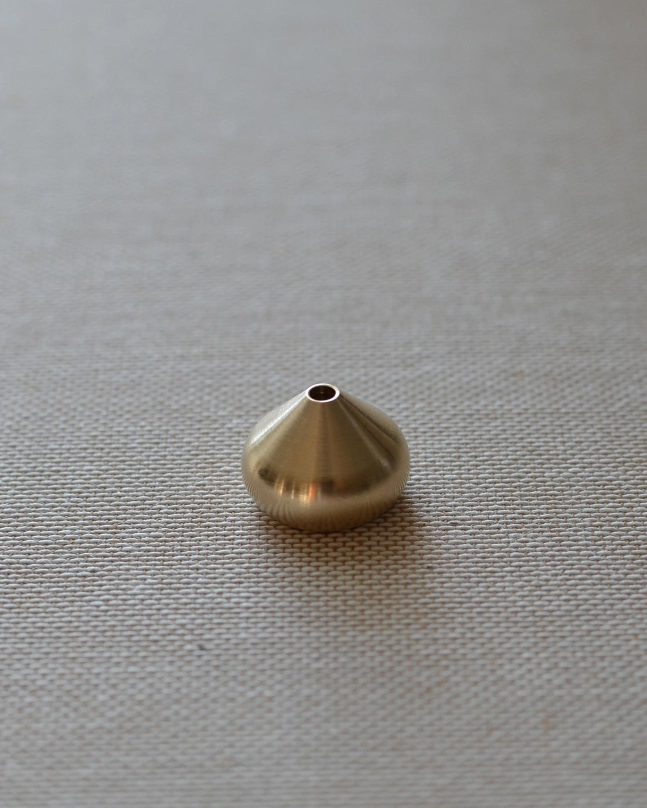 Medium brass waterdrop incense holder shown alone on a neutral surface, suitable for core and coreless incense.