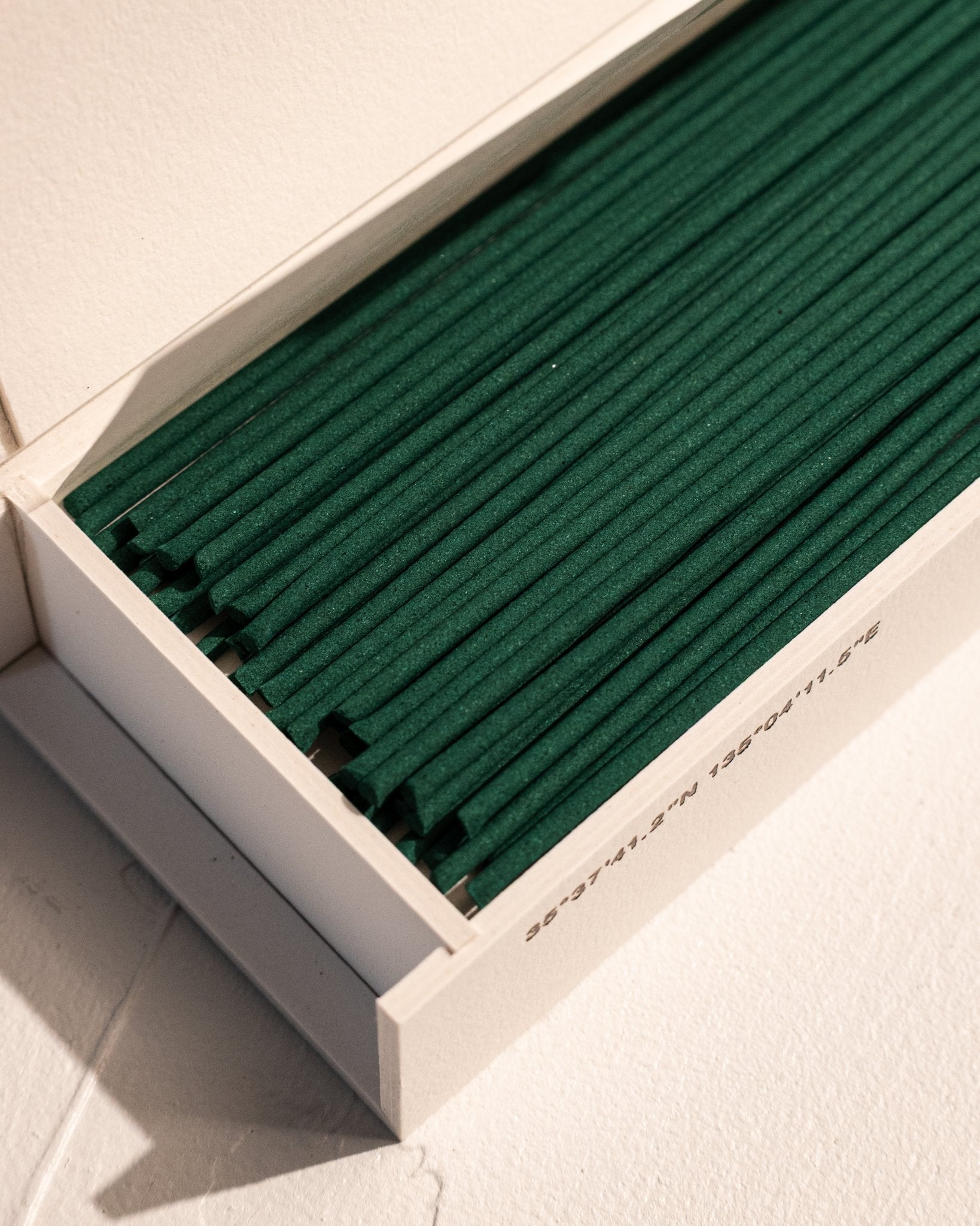 Close-up of IYÉ No. 009 Cedarwood incense sticks in gift box