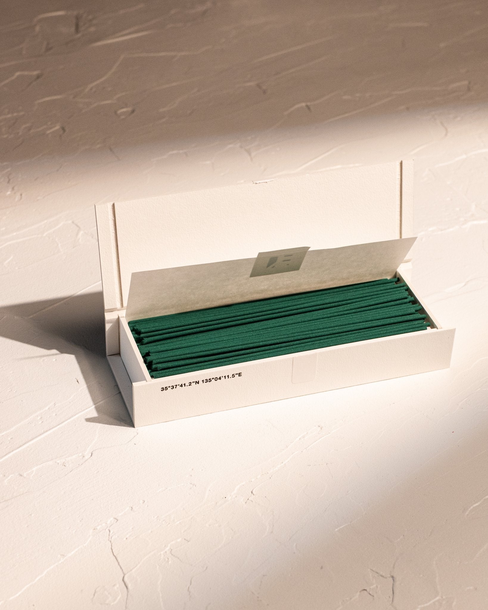 Open box of IYÉ No. 009 Cedarwood coreless incense, handmade in Japan