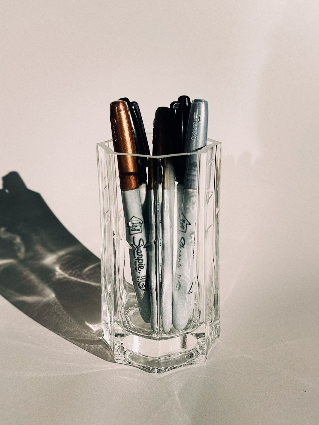 A recycled Saint Germain bottle after the burn, repurposed as a pen holder.