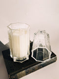All Sacred with the empty Saint Germain glass beside it. The eight-sided shape and thick base were inspired by old cathedral glass, making each one feel like a small architectural object.