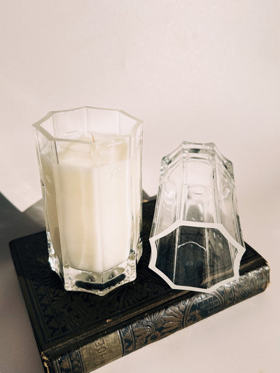 All Sacred with the empty Saint Germain glass beside it. The eight-sided shape and thick base were inspired by old cathedral glass, making each one feel like a small architectural object.