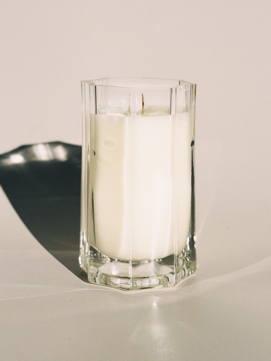 Medium Close up of All Sacred candle in warm natural light