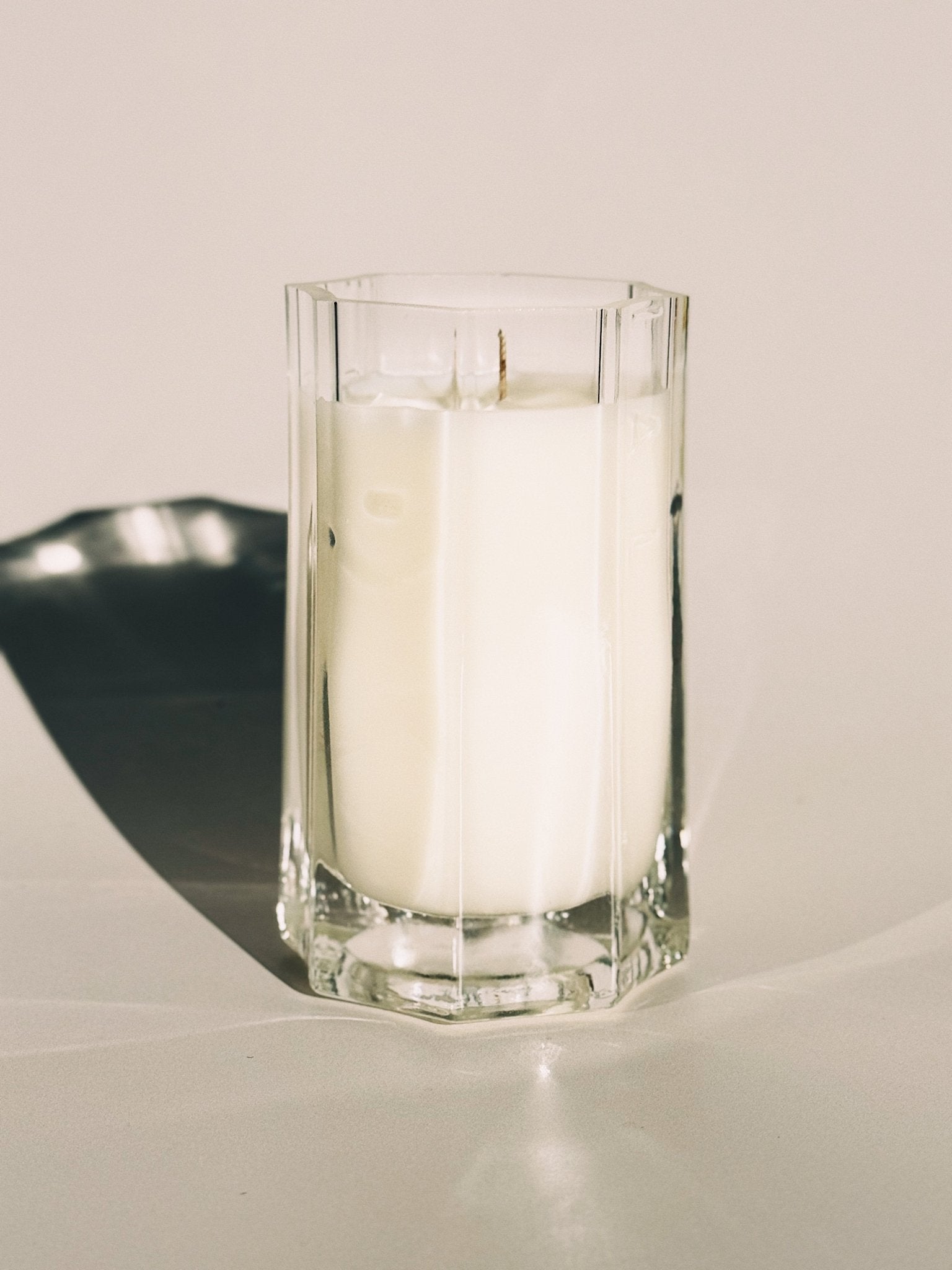 Medium Close up of All Sacred candle in warm natural light