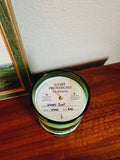 Top view of Wooded Julep candle by Light Provisions in green recycled Jameson glass