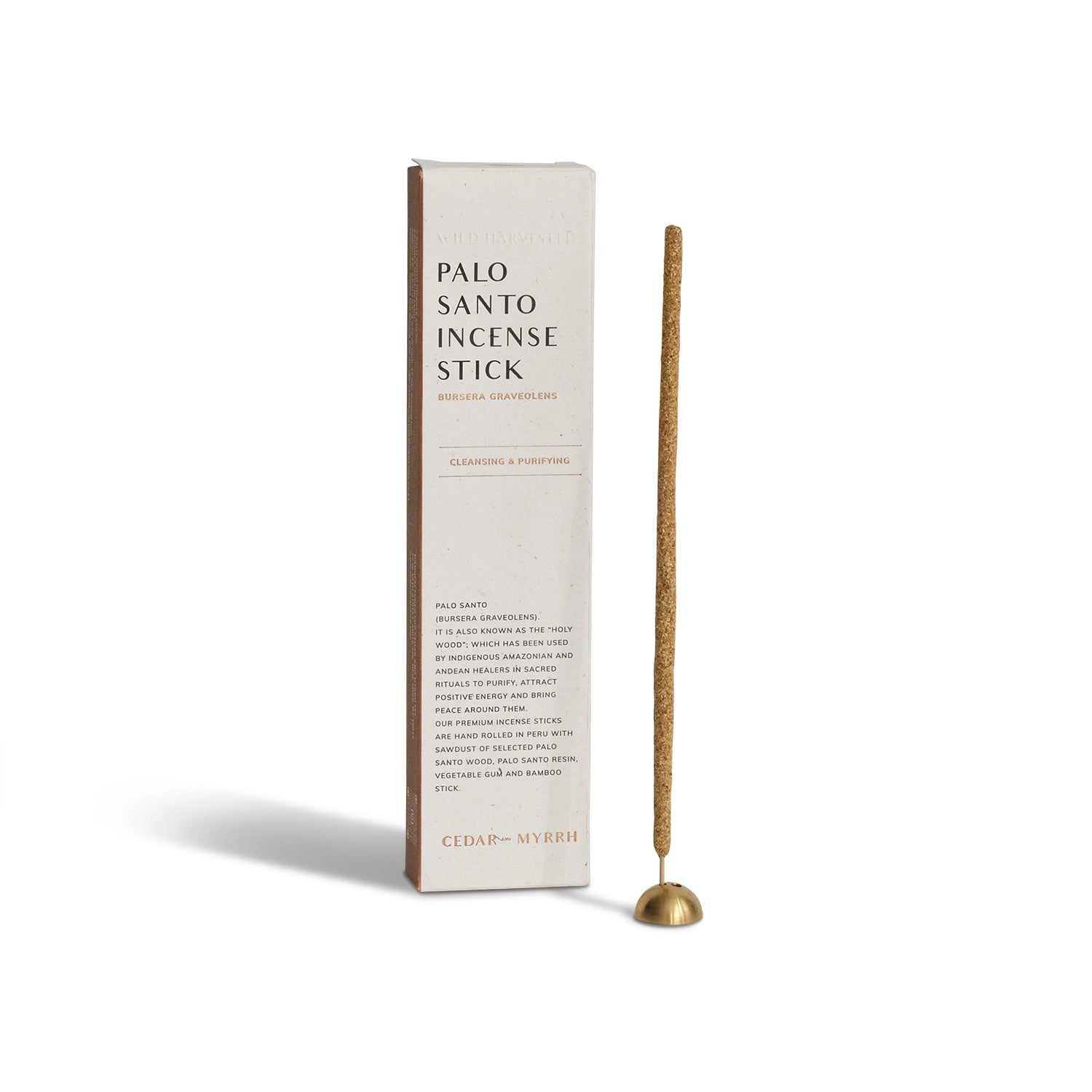 Palo Santo hand-rolled incense stick with brass holder, photographed beside the product box on a neutral background.