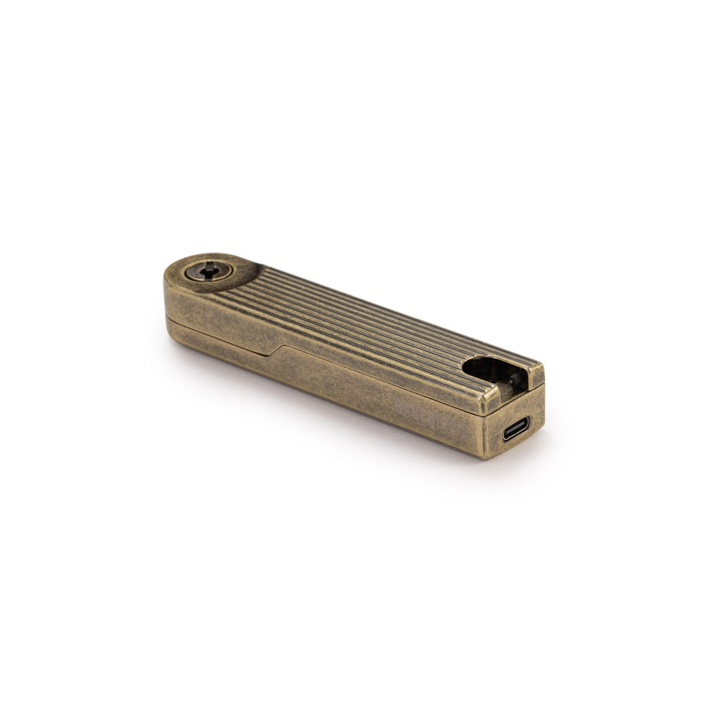 Closed brass Pivot Arc Lighter lying flat on a white background