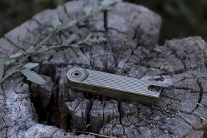 Barebones Pivot Arc Lighter - Light Provisions - Accessory, Resting on Outdoor Wooden Surface