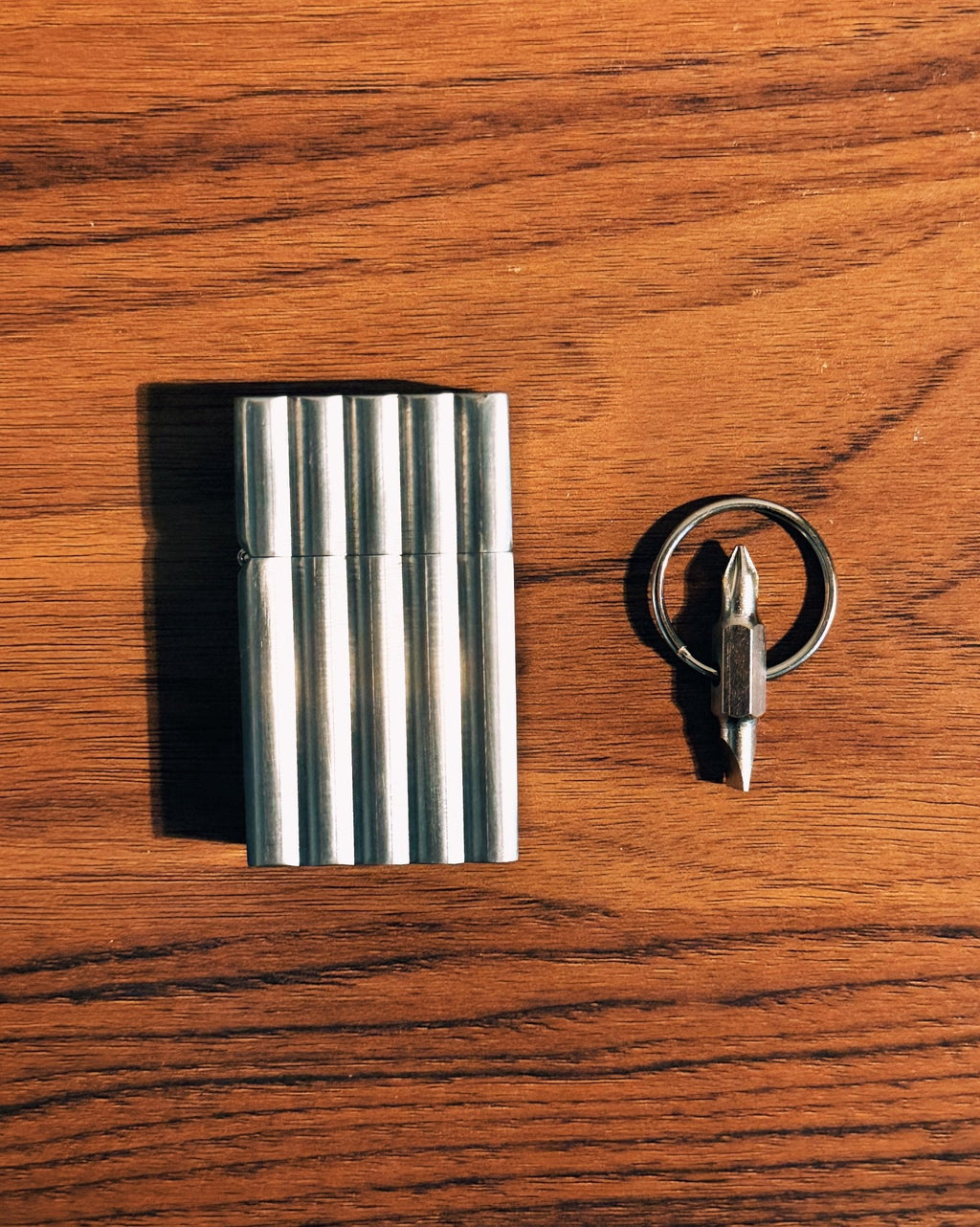 Pocket maintenance screwdriver beside a Tsubota Pearl Hard Edge Aluminum Wave lighter