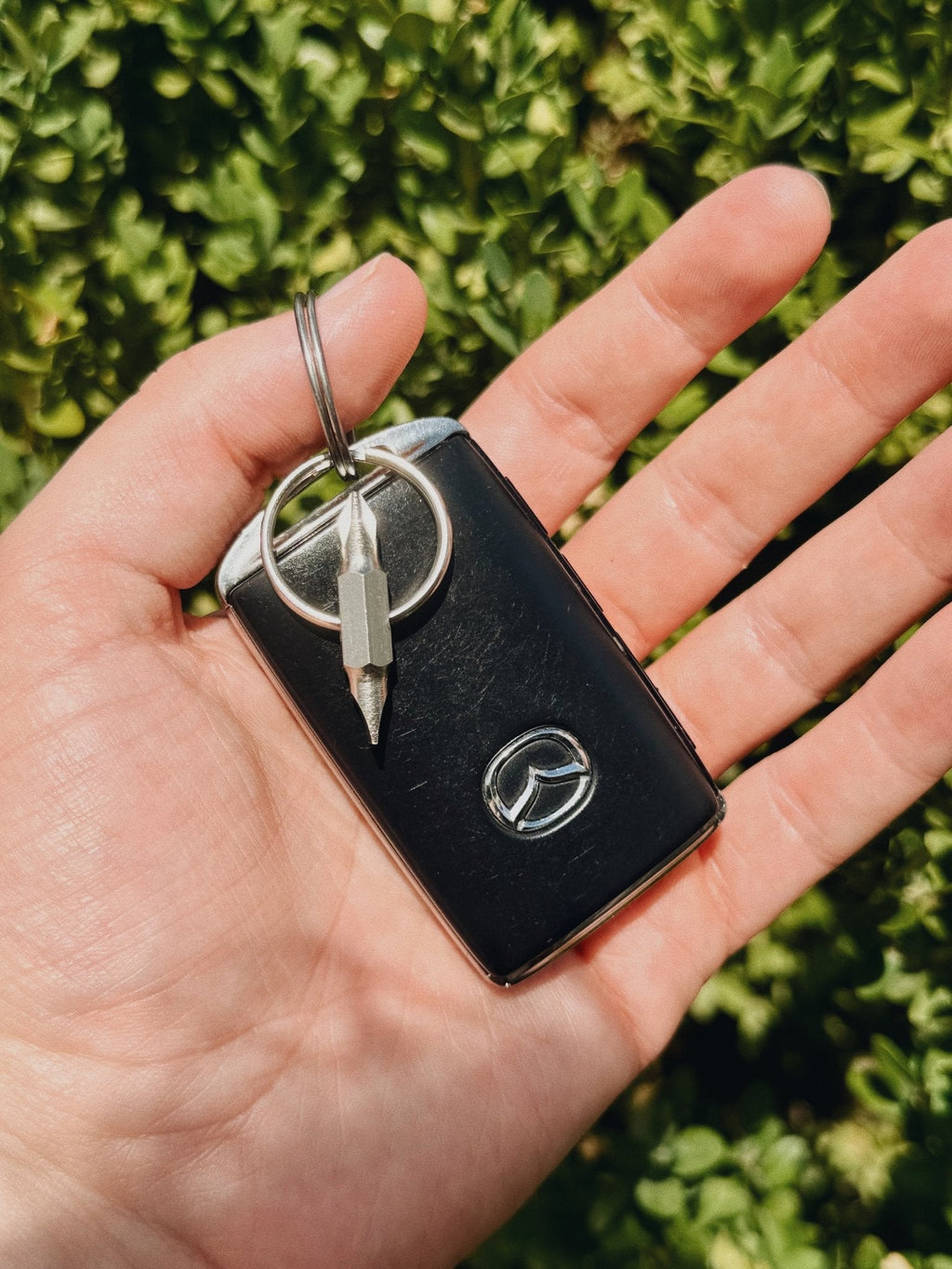 Compact dual-tip pocket screwdriver attached to a keyring with house keys